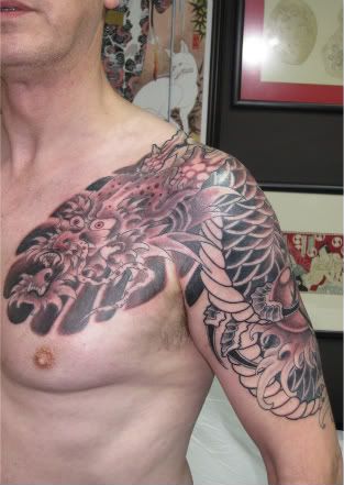 Dragon half sleeve and chest plate in progress on Brian Tattoo by Rich