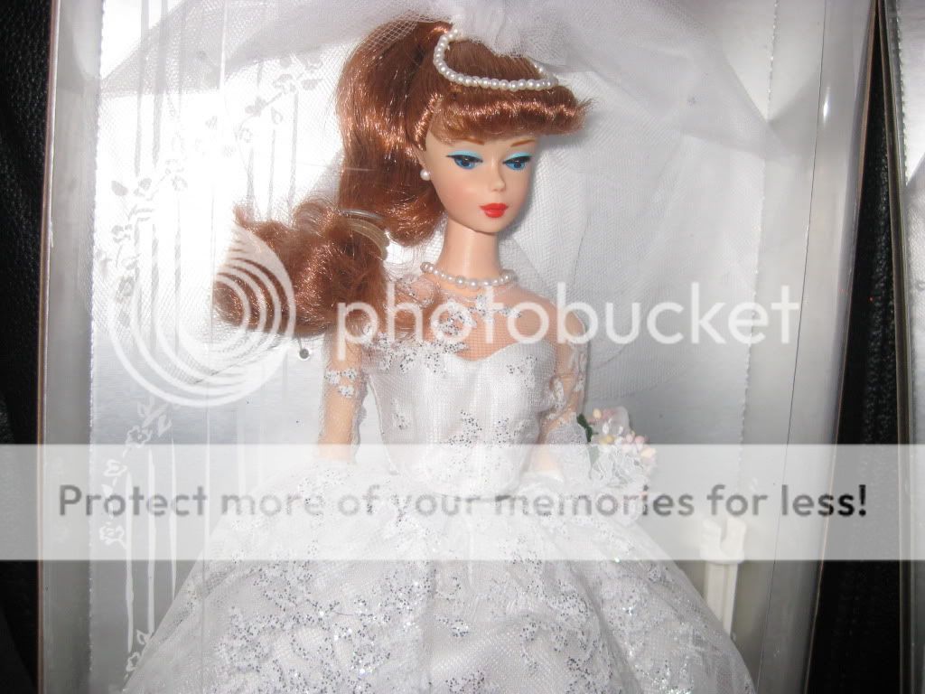 readhead barbie has reddish hair up in a ponytail blue eyes barbie 